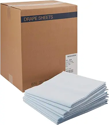 Stack of white drape sheets beside a cardboard box.