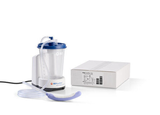 White medical suction device with tubing and mask next to its box.