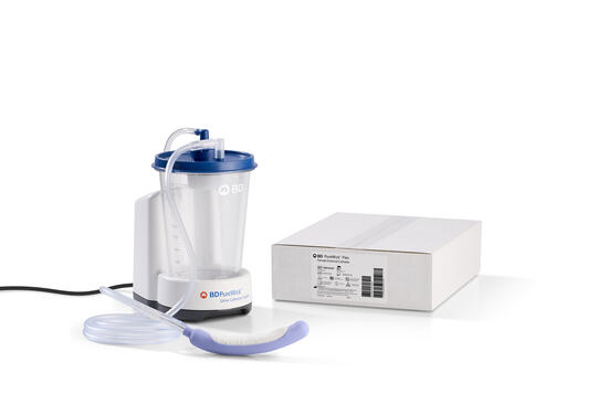 White medical suction device with tubing and mask next to its box.
