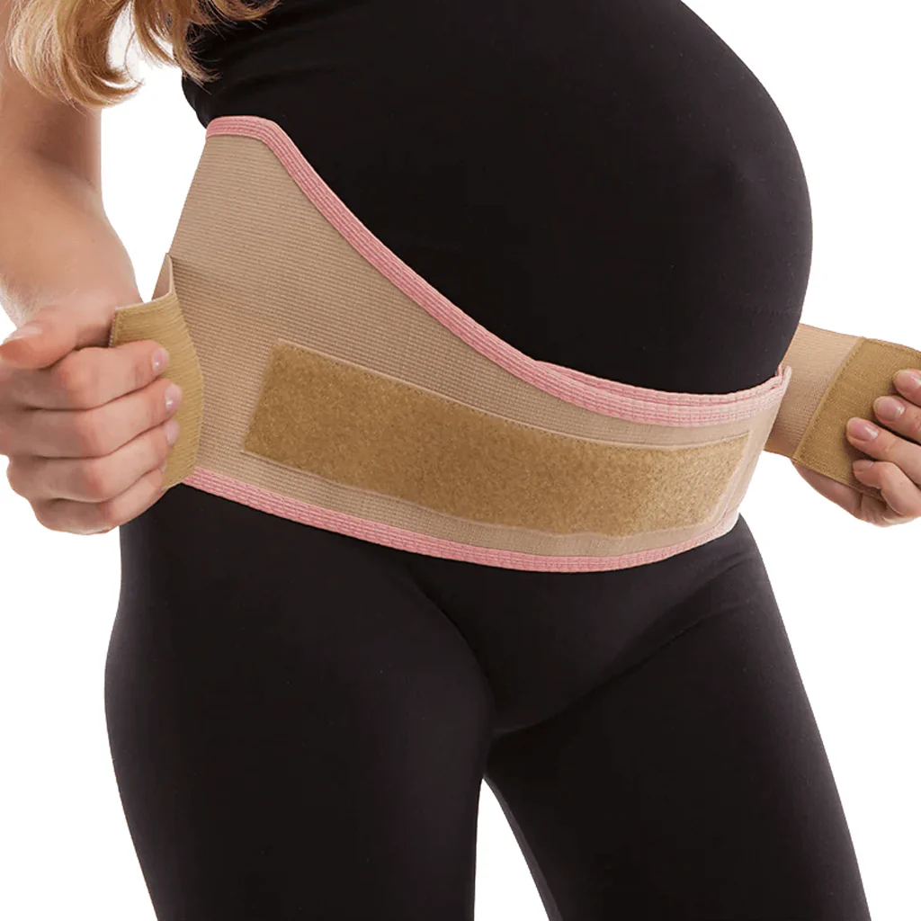 A person wearing a maternity support belt over black clothing.