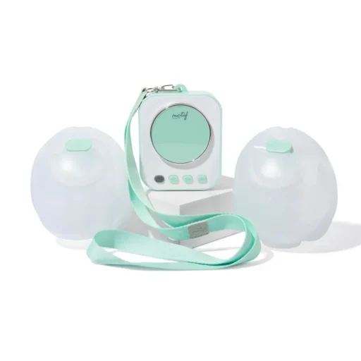 Portable breast pump with two collection bottles and strap in soft pastel green.