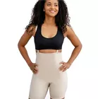 Smiling woman in black sports bra and beige high-waisted shorts.